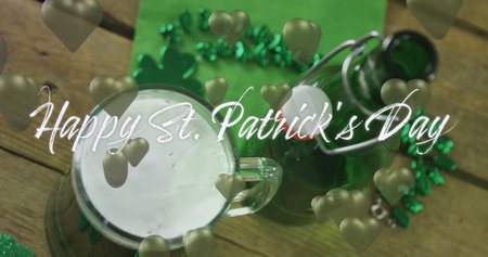 Image of st patrick&#39;s day text and green hearts and glass of beer on wooden background. St patrick&#39;s day, irish tradition and celebration concept digitally generated image.の写真素材