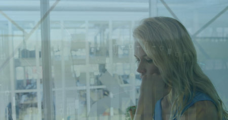 Image of data processing over caucasian businesswoman in office. Global business and digital...