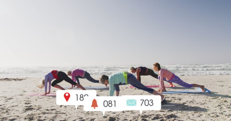 Image of social media data processing over diverse women exercising on beach. Global fitness,...