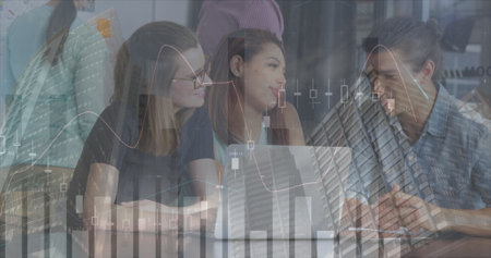 Image of finance data over group of diverse businesspeople working with technology in office....