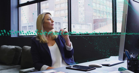 Image of financial data processing over caucasian businesswoman in office. Global finance, business, connections, computing and data processing concept digitally generated image.の写真素材