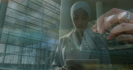 Image of women using computer over muslim businesswomen. global business, success, connections and data processing concept digitally generated image.の写真素材