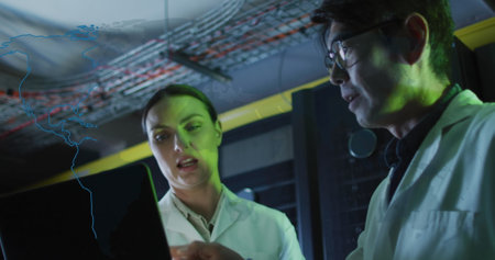 World map against diverse male and female engineers with laptop working in server room. Business...