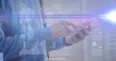 Image of graphs over hands of caucasian man using smartphone. economy, finance, communication and technology concept digitally generated image,の写真素材