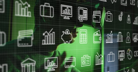 Multiple digital icons moving against asian man wearing vr headset. Business and futuristic technology conceptの写真素材