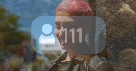 Image of social media icons over woman using smartphone. Social media and communication concept digitally generated image.の写真素材