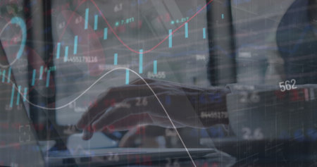 Image of stock market data processing over mid section of businessman using laptop at a cafe. Global economy and business data technology conceptの写真素材