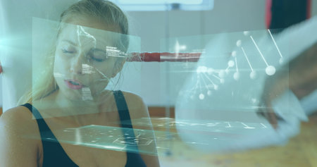 Image of data processing and dna strand over caucasian woman at gym. Global sport, computing and digital interface concept digitally generated image.の写真素材
