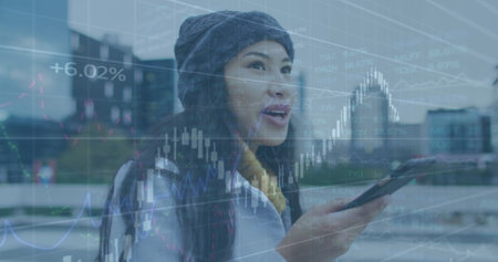 Image of financial data processing over businesswoman using smartphone. Global business, finance,...