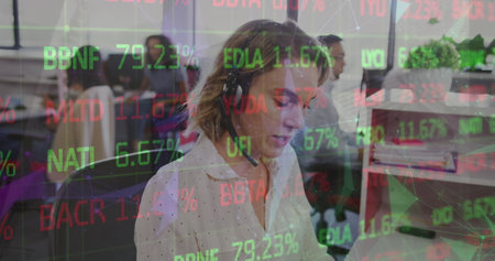 A businesswoman is talking on the phone in a busy office. Global communication business connections...