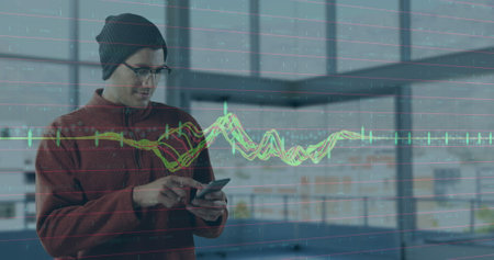 Image of financial data processing over businessman using smartphone. Global business, finance,...