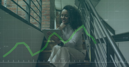 Image of financial data processing over biracial businesswoman in office. Global business, finance, computing and data processing concept digitally generated image.の写真素材