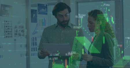 Image of financial data processing over caucasian man and woman discussing over a document. Global...