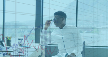 Image of financial graphs and data over african american man in office. Business, finance and...