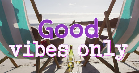 Good vibes text against couple holding hands while sunbathing at the beach. travel and vacation conceptの写真素材