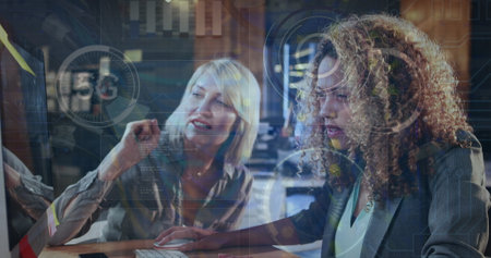 A woman is working on a computer in an office.の写真素材
