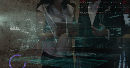 Image of graphs and data over diverse coworkers in office. Business, finance and economy concept digitally generated image.の写真素材