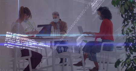 Image of graphs and data over diverse coworkers in face masks in office. Business, finance and...