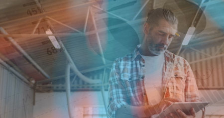 Image of data processing over caucasian man using tablet. Global business and digital interface concept digitally generated image.の写真素材