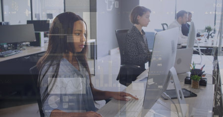 The colleagues are typing on their computers.の写真素材
