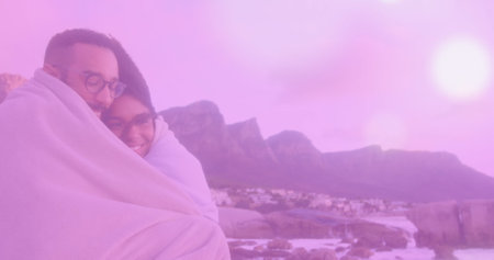 Image of glowing spots over diverse couple. Lifestyle and free time concept digitally generated...