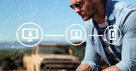 Image of connections with icons over caucasian man using smartphone. Connections, networks, data processing and technology concept digitally generated image.の写真素材