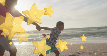 Image of stars over biracial man with grandson at beach. Christmas, celebration and digital interface concept digitally generated image.の写真素材