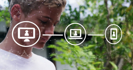 Caucasian brother wearing white shirt, looking at digital icons. He has short blond hair, blue eyes,...