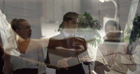 Image of caucasian businesswoman using computer over diverse business people talking. Global business and digital interface concept digitally generated image.の写真素材