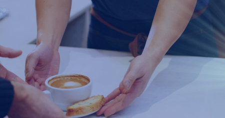 Person handing over coffee and cake to another, both standing at table. Warm beverage and dessert sharing, creating moment of hospitality and careの写真素材