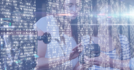 Image of light spots over caucasian women paying with credit card. Global business and digital interface concept digitally generated image.の写真素材