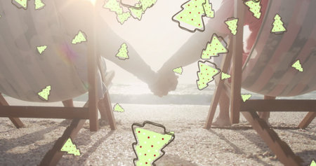 Image of ginger bread icons over senior biracial couple at beach. Christmas, celebration and digital interface concept digitally generated image.の写真素材