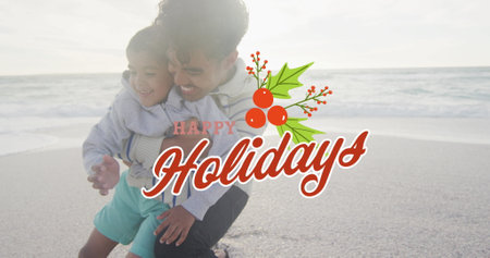 Image of happy holidays text over biracial father and son at beach. Christmas, celebration and digital interface concept digitally generated image.の写真素材