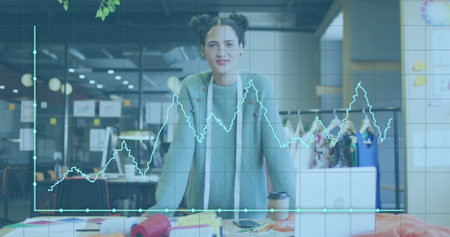 Image of financial data processing over biracial businesswoman in office. Global business, finance, computing and data processing concept digitally generated image.の写真素材