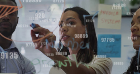 Image of data processing over diverse business people in office. Global finance, business, connections, computing and data processing concept digitally generated image.の写真素材