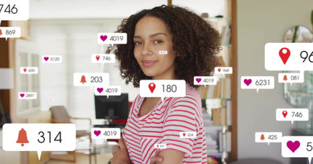 Image of multiple notification bars over smiling biracial woman standing arms crossed in office. Digital composite, multiple exposure, close up, social media reminder and technology concept.の写真素材