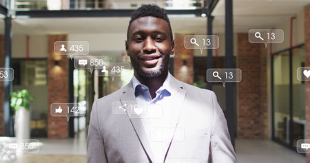 Image of changing numbers, icons in notification bars, close up of smiling african american man. Digital composite, multiple exposure, business, growth, social media reminder concept.の写真素材