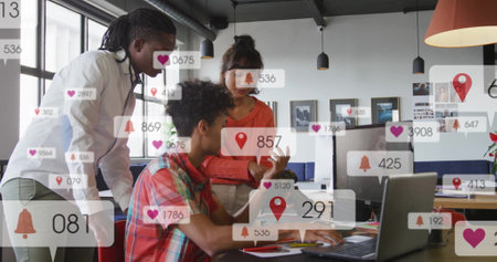 Image of notification bars over diverse coworkers discussing reports on laptop in office. Digital composite, multiple exposure, planning, social media reminder, teamwork and technology concept.の写真素材