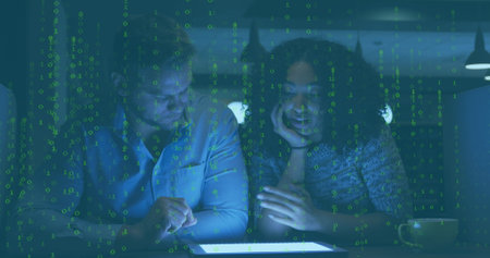 Image of data processing over diverse male and female colleagues using digital tablet at office. Computer interface and business technology conceptの写真素材