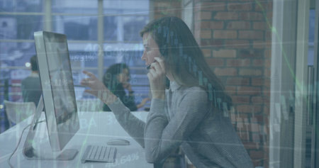 Image of financial data processing over caucasian businesswoman using smartphone. Global business, finance, computing and data processing concept digitally generated image.の写真素材