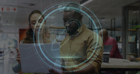 Image of cyber security text and key icon, diverse colleagues discussing over laptop in office. Digital composite, protection, privacy, data, network, technology, business, teamwork and office.の写真素材