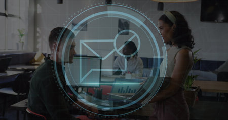 Image of cyber security text and envelope icon, caucasian coworkers discussing over laptop. Digital composite, protection, privacy, data, message, technology, business, teamwork and office.の写真素材