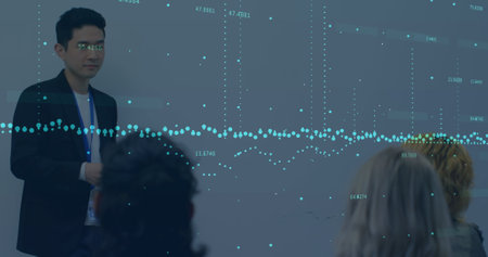 Image of financial data over asian businessman making presentation. global business, finance, economy and technology concept digitally generated image.の写真素材