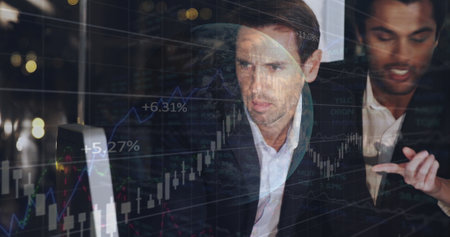 Image of financial data processing and globe over diverse business people in office. global business, data processing and digital interface concept digitally generated image.の写真素材