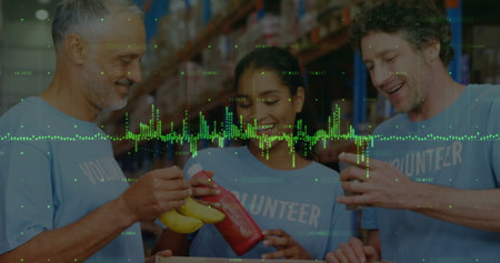 Image of financial graphs over happy diverse female and male warehouse workers. business, finance and delivery services concept digitally generated image.の写真素材