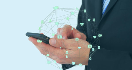 Image of globe of connections with icons over businessman using smartphone. Global computing,...