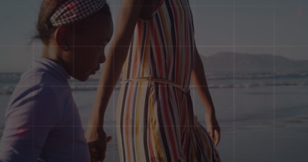 Image of network of connections over african american mother and daughter at beach. Global sport and digital interface concept digitally generated image.の写真素材