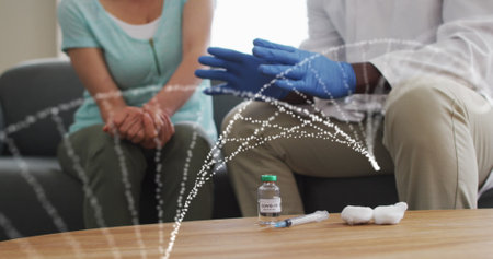 Image of dna strand over diverse doctor and patient. Global connections and digital interface concept digitally generated image.の写真素材