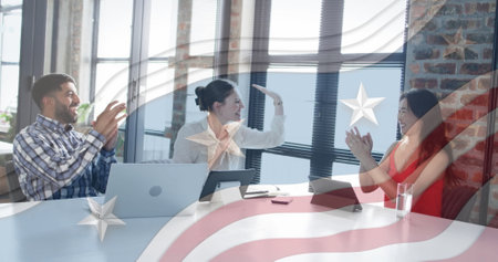 Celebrating business success, diverse team in office over American flag image. teamwork,...