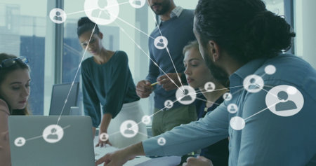 Image of network of connections with people icons over diverse business people in office. Global finance, business, connections, computing and data processing concept digitally generated image.の写真素材